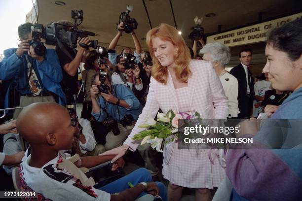 Sarah Ferguson , Her Royal Highness The Duchess of York, greets leukemia patient Kevin Burroughs from Compton outside the Children's Hospital in Los...