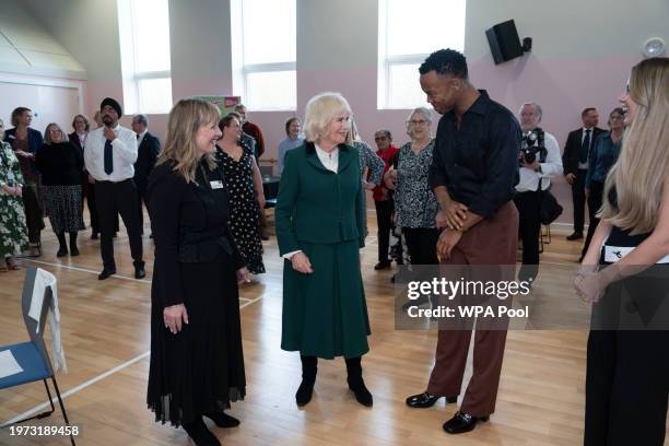 Queen Camilla, President of the Royal Voluntary Service speaks with dancer Johannes Radebe, a star on Strictly Come Dancing during a visit to the...