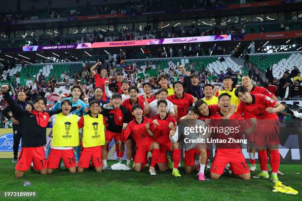 Players and staff of South Korea celebrate victory after the penalty shootout during the AFC Asian Cup Round of 16 match between Saudi Arabia and...