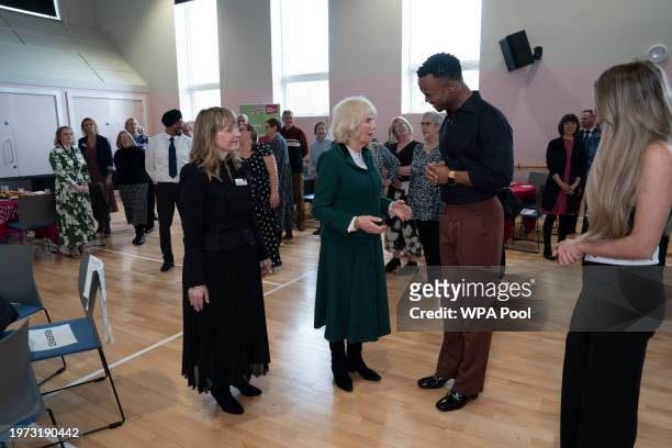Queen Camilla, President of the Royal Voluntary Service speaks with dancer Johannes Radebe, a star on Strictly Come Dancing during a visit to the...