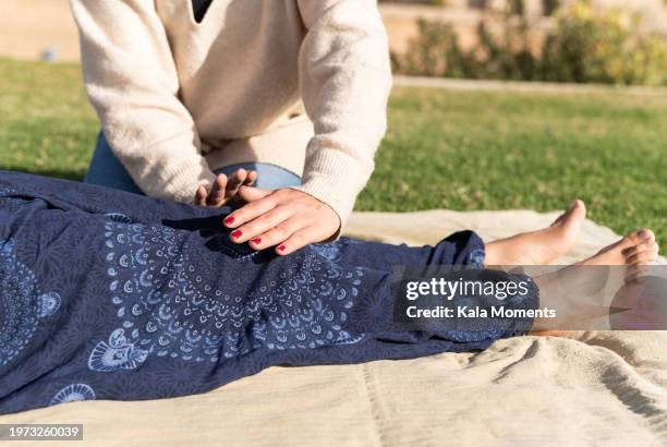 woman during an energy healing above client - reiki fotografías e imágenes de stock