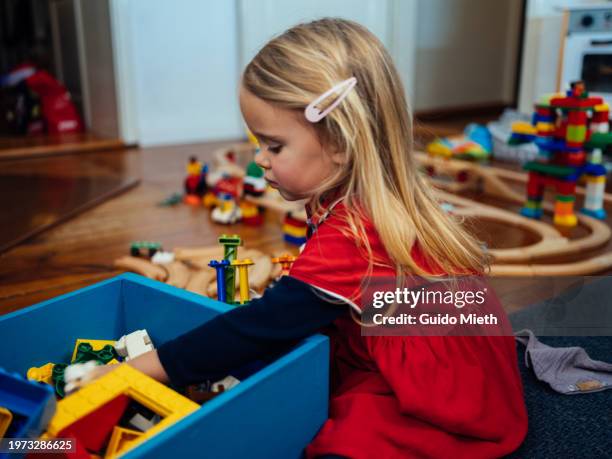 little girl playing with blocks and little train at home. - school railings stock pictures, royalty-free photos & images