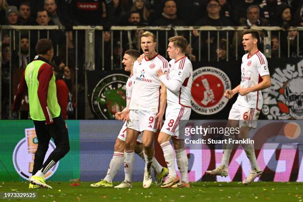 Vincent Vermeij of Fortuna Duesseldorf celebrates with teammates after scoring his team's first goal from the penalty-spot during the DFB cup...
