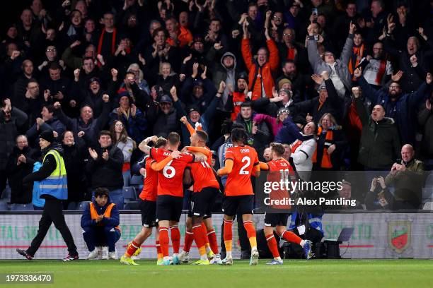 Elijah Adebayo of Luton Town celebrates scoring his team's third goal with teammates during the Premier League match between Luton Town and Brighton...