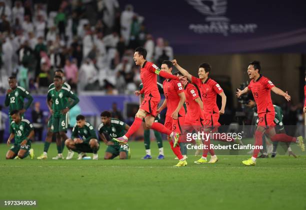 Son Heung-Min of South Korea and team mates celebrate victory after the penalty shootout during the AFC Asian Cup Round of 16 match between Saudi...