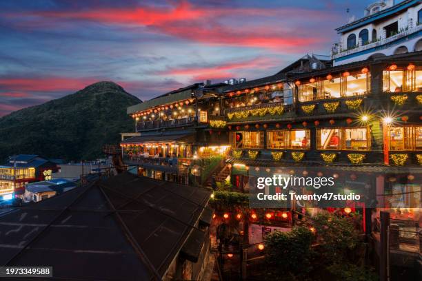 jiufenbeautifully illuminated old-style teahouses in jiufen old town at sunset in taiwan - taipei stock pictures, royalty-free photos & images