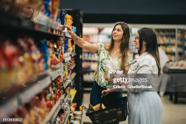 two female friends shopping in supermarket - stormarknad bildbanksfoton och bilder