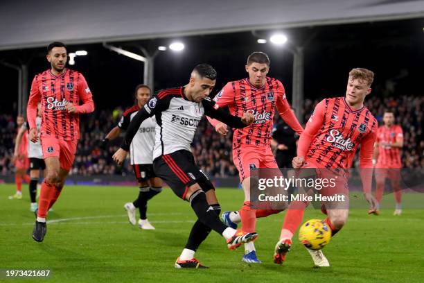 Andreas Pereira of Fulham takes a shot whilst under pressure from Vitaliy Mykolenko and Jarrad Branthwaite of Everton during the Premier League match...