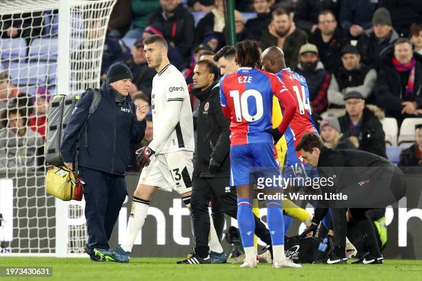 Ivo Grbic of Sheffield United is substituted off after colliding with Jean-Philippe Mateta of Crystal Palace during the Premier League match between...