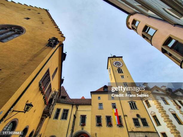 the old town hall with tower (altes rathaus), regensburg, germany - bavarian man in front of house stock-fotos und bilder