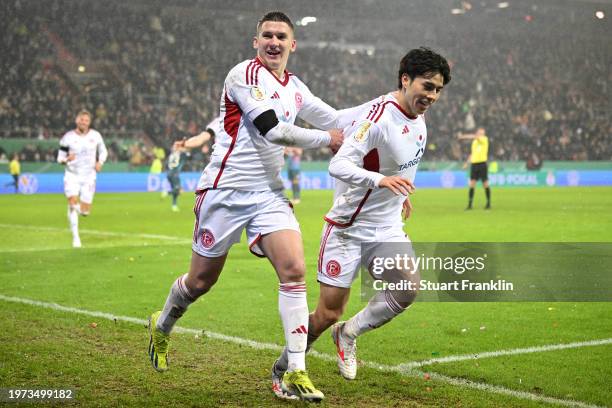 Ao Tanaka of Fortuna Duesseldorf celebrates with Christos Tzolis of Fortuna Duesseldorf after scoring his team's second goal during the DFB cup...