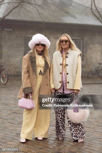 Guest wears pale yellow pants, a matching top, a beige coat, a pink bag, and a pink fur hat and a guest wears animal print pants, a pink shirt, a...