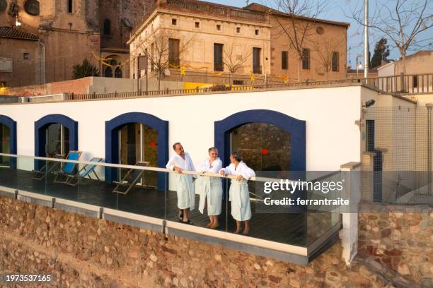 mature friends enjoying public hot spring - bathhouse stock pictures, royalty-free photos & images