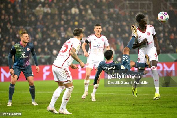 Elias Saad of FC St. Pauli attempts an overhead kick on goal whilst under pressure from Joshua Quarshie of Fortuna Duesseldorf during the DFB cup...