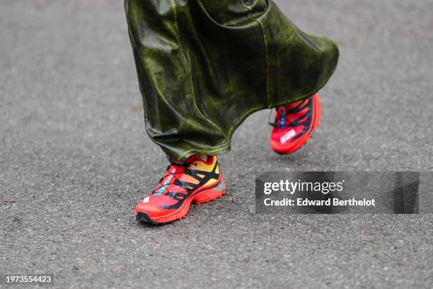 Close-up detail view of red Salomon sneakers shoes, outside Aeron, during the Copenhagen Fashion Week AW24 on January 30, 2024 in Copenhagen, Denmark.