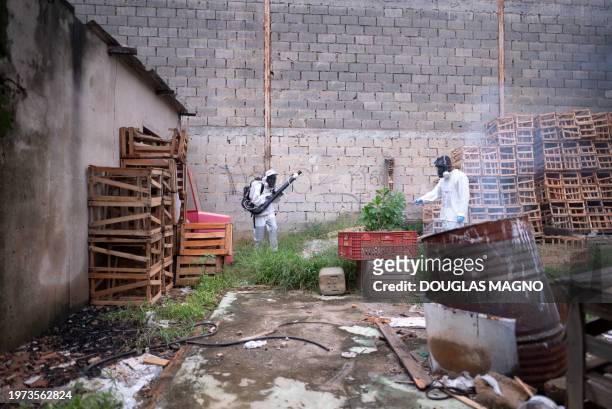 Health workers fumigate against the Aedes aegypti mosquito, a vector of the dengue, Zika, and Chikungunya viruses in Contagem, metropolitan region of...