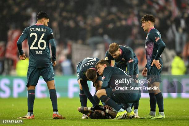 The players of FC St. Pauli look dejected after defeat in the penalty-shoot-out following the DFB cup quarterfinal match between FC St. Pauli and...