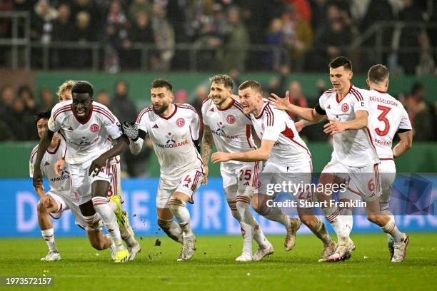 The players of Fortuna Duesseldorf celebrate after winning in the penalty shoot out following the DFB cup quarterfinal match between FC St. Pauli and...