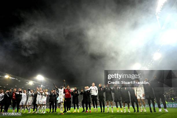 The players and coaching staff of Fortuna Duesseldorf celebrate after victory in the DFB cup quarterfinal match between FC St. Pauli and Fortuna...