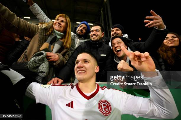 Christos Tzolis of Fortuna Duesseldorf celebrates with the fans at full-time after victory in the DFB cup quarterfinal match between FC St. Pauli and...