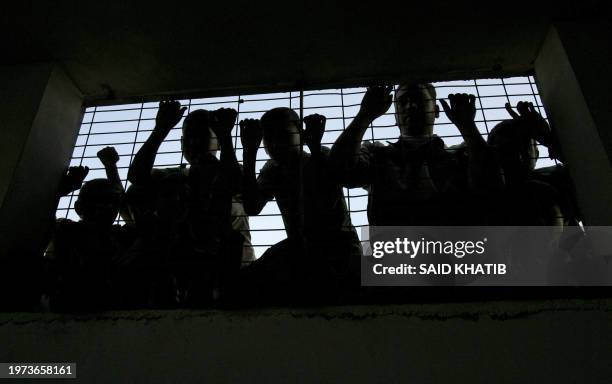 Palestinian youths follow the funeral of Mohammed and Ziad Abu Anza from Hamas's Ezzedine al-Qassam Brigades at a mosque in Khan Yunis in the...