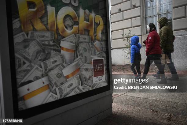 People walk past the Internal Revenue Service building in Washington, DC, in February 2, 2024.