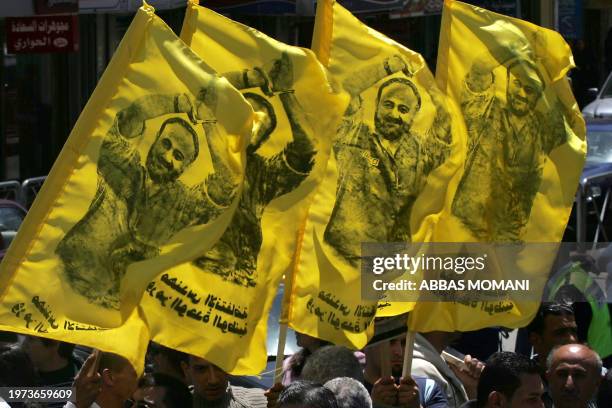 Palestinians hold up images of Marwan Barghuti, a Fatah leader jailed in Israel, during a rally calling for the release of Palestinian prisoners from...