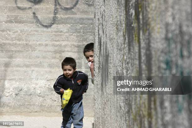 Palestinian children play in the alleys of al-Bustan, in the east Jerusalem neighborhood of Silwan on February 24, 2009 where around 90 Palestinian...