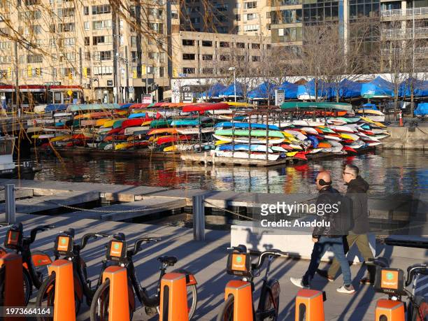 People enjoy the sunny weather at HTO Park's urban beach as daily life continues in Toronto, Ontario on February 2, 2024.