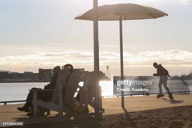 People enjoy the sunny weather at HTO Park's urban beach as daily life continues in Toronto, Ontario on February 2, 2024.