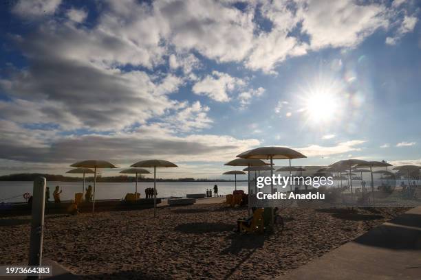 People enjoy the sunny weather at HTO Park's urban beach as daily life continues in Toronto, Ontario on February 2, 2024.