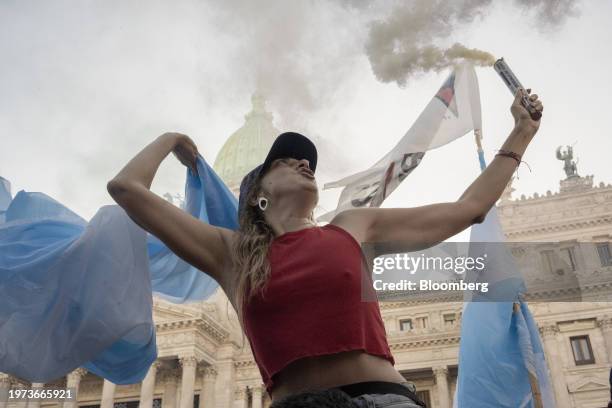 Demonstrator with a smoke flare during a protest against the "omnibus" bill in front of the National Congress in Buenos Aires, Argentina, on Friday,...