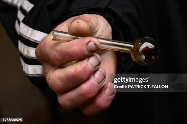 Person holds a glass pipe used to smoke meth following the decriminalization of all drugs in downtown Portland, Oregon on January 25, 2024. Since...