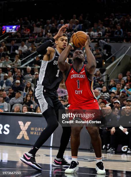 Zion Williamson of the New Orleans Pelicans shoots past Victor Wembanyama of the San Antonio Spurs in the second half at Frost Bank Center on...