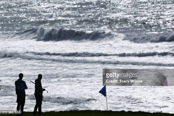 Scottie Scheffler is silhouetted by the ocean during the second round of AT&T Pebble Beach Pro-Am at Pebble Beach Golf Links on February 2, 2024 in...