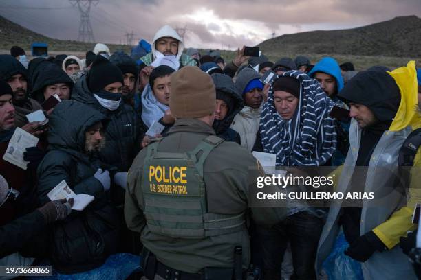 Asylum seekers rush to be processed by border patrol agents at an improvised camp near the US-Mexico border in eastern Jacumba, California, on...