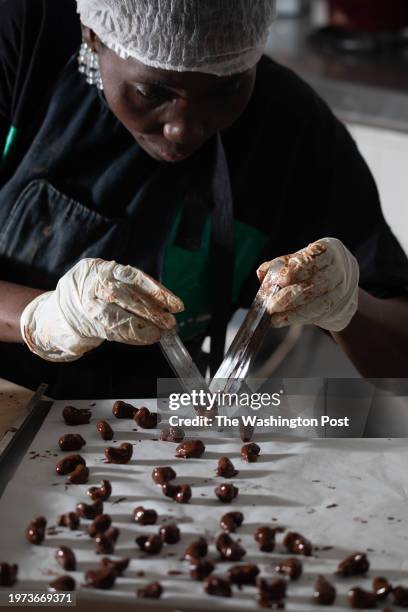 Manufacturing cashew nuts coated with fine chocolate in the kitchens of the Bushman Café in Abidjan on November 9, 2023.