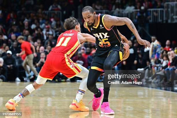 Trae Young of the Atlanta Hawks steals ball during the game against the Phoenix Suns on February 2, 2024 at State Farm Arena in Atlanta, Georgia....