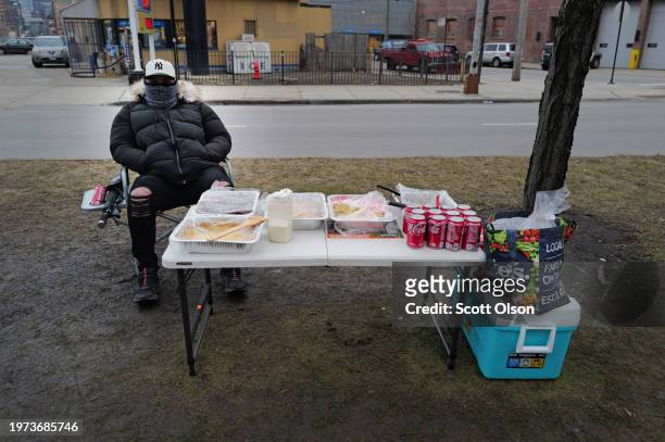 Man who recently emigrated from Venezuela, sells homemade cake slices and sodas to migrants staying at a nearby shelter in the West Loop neighborhood...