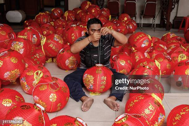 Man is preparing lanterns for the upcoming Chinese New Year celebration at Dharmayana Temple in Kuta, Bali, Indonesia, on February 3, 2024. The...