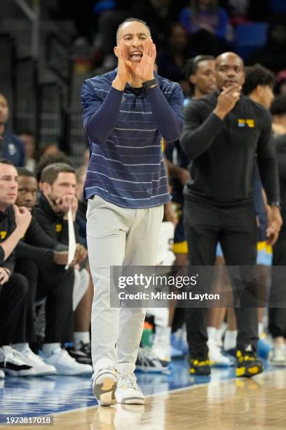 Head coach Shaka Smart of the Marquette Golden Eagles yells instructions to his players during a college basketball game against the DePaul Blue...