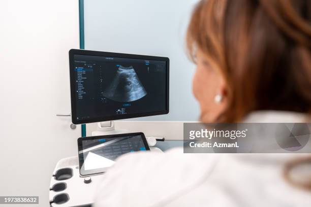 mature caucasian female engaged in ultrasound exam - throat exam 個照片及圖片檔