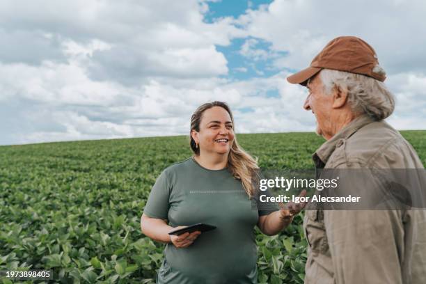 female agronomist and farmer talking on plantation - side dish stock pictures, royalty-free photos & images
