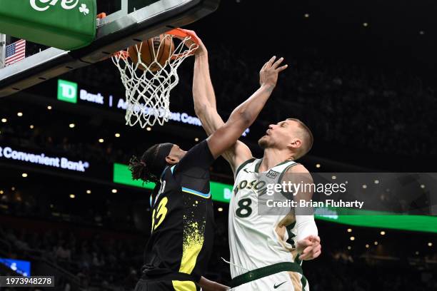 Kristaps Porzingis of the Boston Celtics dunks and scores against Myles Turner of the Indiana Pacers during the third quarter at the TD Garden on...