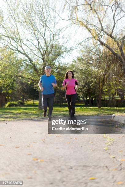 elderly couple having a jogging session in the park - mexico training session stock pictures, royalty-free photos & images