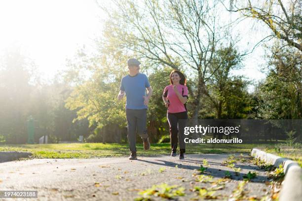 elderly couple have a jogging session at the park - mexico training session stock pictures, royalty-free photos & images