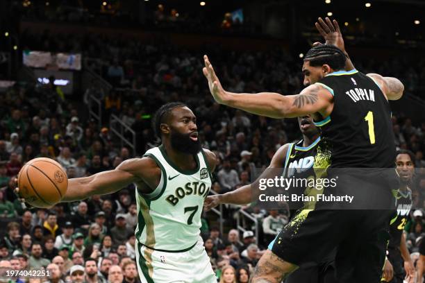 Jaylen Brown of the Boston Celtics passes around Obi Toppin of the Indiana Pacers during the fourth quarter at the TD Garden on January 30, 2024 in...