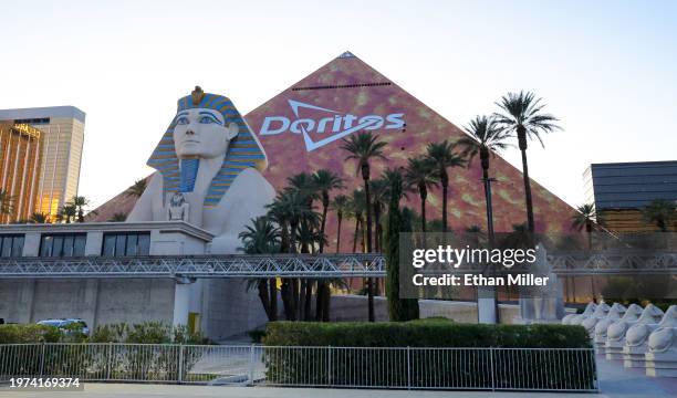 The triangular, Las Vegas Strip side of Luxor Hotel and Casino is covered in an orange advertisement for Doritos ahead of Super Bowl LVIII on January...