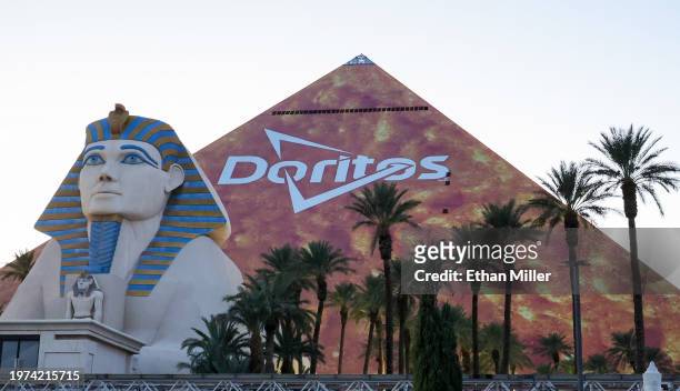 The triangular, Las Vegas Strip side of Luxor Hotel and Casino is covered in an orange advertisement for Doritos ahead of Super Bowl LVIII on January...