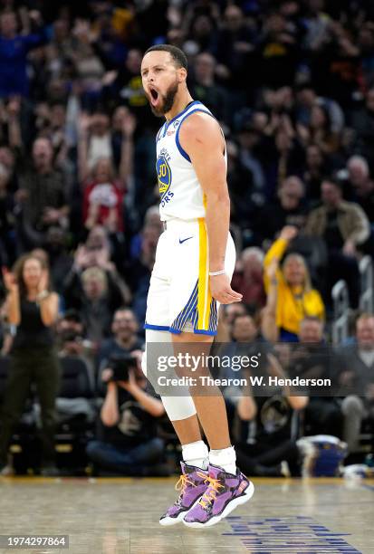 Stephen Curry of the Golden State Warriors reacts after making a three-point shot against the Philadelphia 76ers during the fourth quarter at Chase...